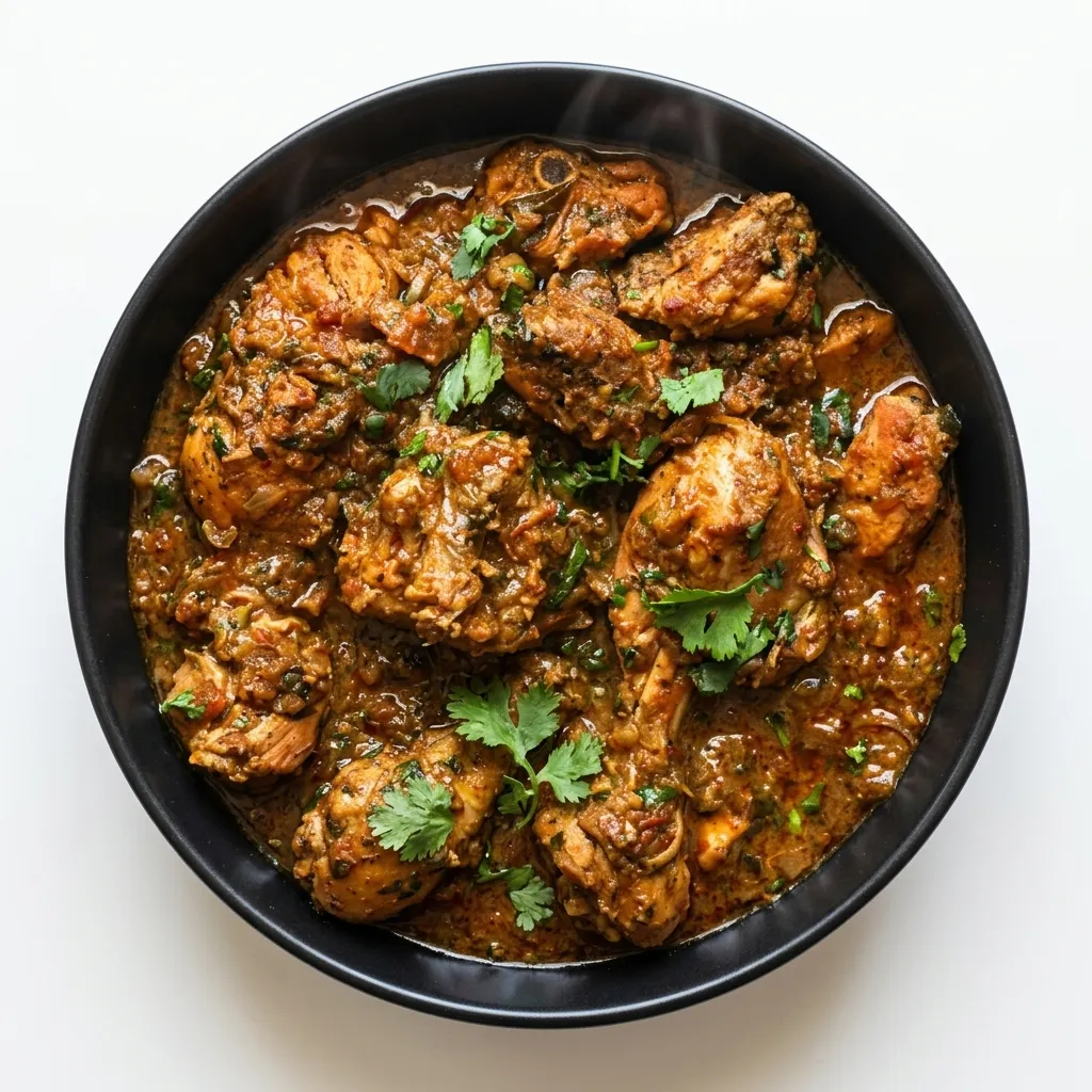 Home-style Indian chicken curry with whole spices in a bowl at Indian Tales in Calgary NE